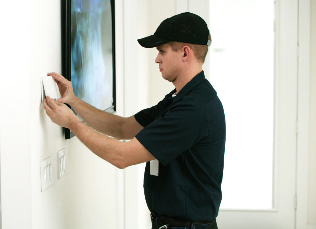Security system technician reviewing current alarm system